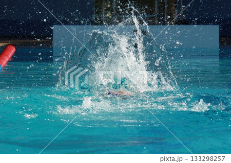 Swimming competition in the swimming pool, close up of water splashes Swimming competition in the swimming pool, close up of water splashes 133298257