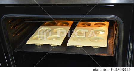 pouring liquid muffin batter into silicone baking mold 133298411