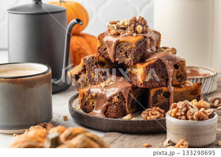 Homemade chocolate brownie cake dessert with pumpkin puree and spices on a plate white table background. Baking Thanksgiving Day or Halloween 133298695