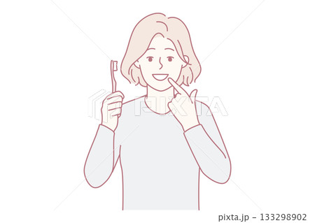 Smiling girl point at clean teeth 133298902