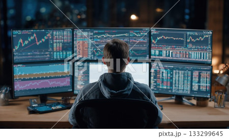 Professional trader analyzing stock market data on multiple monitors displaying charts, graphs, and real-time financial information in a sophisticated trading environment 133299645