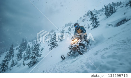 Snowmobile rider navigating steep mountain slope during heavy snowstorm in winter wilderness with dramatic landscape and falling snow 133299716