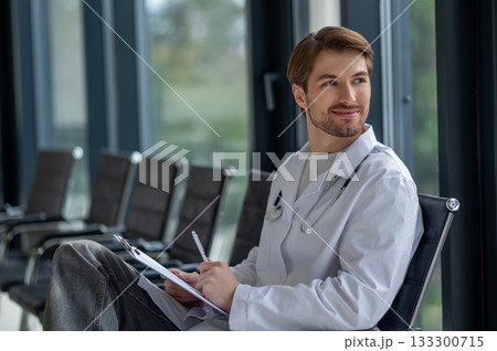 Medical professional doing paperwork in hospital interior Medical professional doing paperwork in hospital interior 133300715