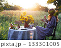 girl sits in the garden and eats a pie 133301005