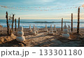 Christmas-themed beach party, sand snowmen, festive decorations, ocean waves . 133301180