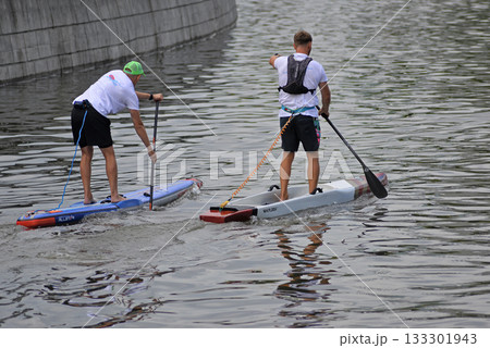 Sup surfing, two athletes Sup surfing, two athletes 133301943