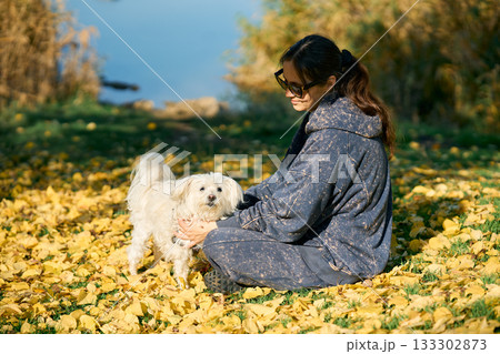 Woman playing with her dog and enjoy loving moment together Woman playing with her dog and enjoy loving moment together 133302873