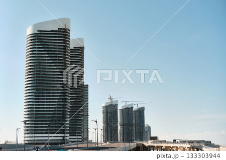 Modern Skyscrapers Under Construction in Urban Skyline 133303944