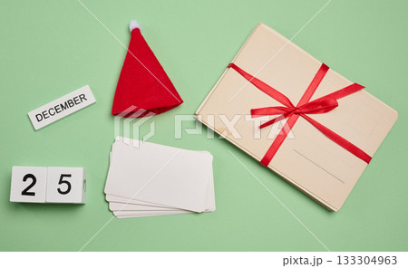 Set of Christmas elements: red Santa hat, cards, blank cards and calendar cubes with the date December 25 133304963