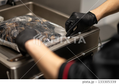 Unrecognizable male cook preparing seafood dish with mussels Unrecognizable male cook preparing seafood dish with mussels 133305339