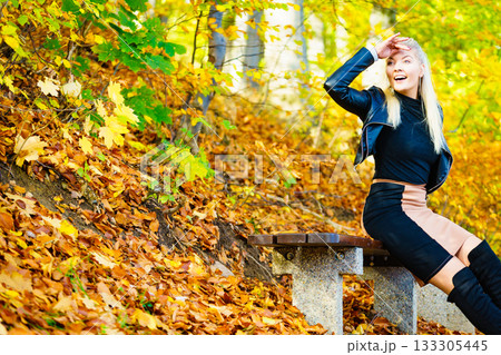 Fashion woman relaxing in autumn park Fashion woman relaxing in autumn park 133305445