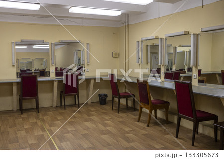 a dilapidated old dressing room in a theater with mirrors and chairs a dilapidated old dressing room in a theater with mirrors and chairs 133305673