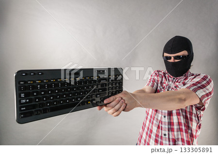 Man wearing balaclava shooting from keyboard 133305891