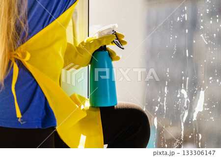 Person spraying window cleaning detergent Person spraying window cleaning detergent 133306147