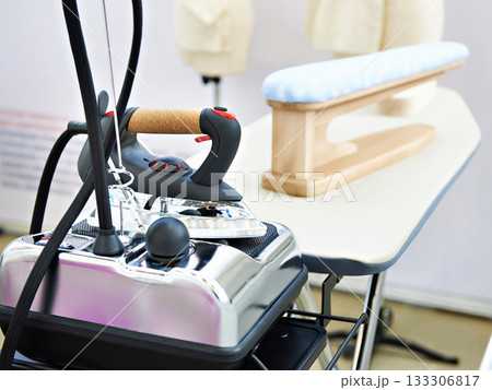 Modern clothes iron and ironing board 133306817