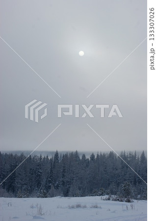 The winter Siberian sun shines in the foggy, grey sky. The winter Siberian sun shines in the foggy, grey sky. 133307026