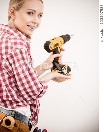 Girl using some power tools for work at home Girl using some power tools for work at home 133307988