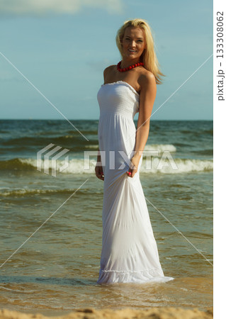 Beautiful blonde girl on beach, summertime 133308062