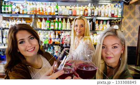 Girls with alcohol glasses in pub club 133308845