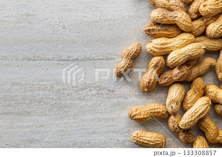 Peanuts in shell. Groundnuts on kitchen table. Top view. 133308857