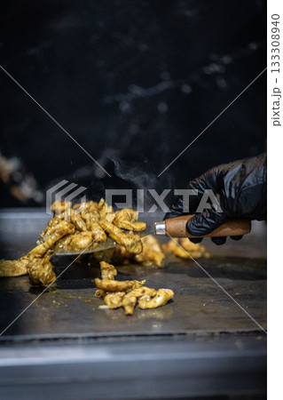Close up photograph of chicken pieces on the barbecue grill 133308940