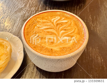 A delicious cappuccino is on the dessert table in the coffee shop A delicious cappuccino is on the dessert table in the coffee shop 133309631