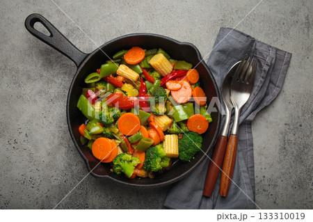 Stir fried colorful mixed vegetables cast iron skillet healthy cooking diet vegan 133310019