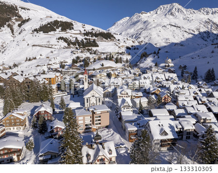Flight over the famous village of Andermatt in Switzerland in winter - aerial photography Flight over the famous village of Andermatt in Switzerland in winter - aerial photography 133310305