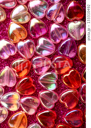Translucent Heart-Shaped Capsules on Glittery Pink Background for Valentines Day Celebration Translucent Heart-Shaped Capsules on Glittery Pink Background for Valentines Day Celebration 133310492