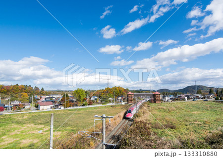 【秋田新幹線】紅葉する市街地を走行する特急こまち 133310880
