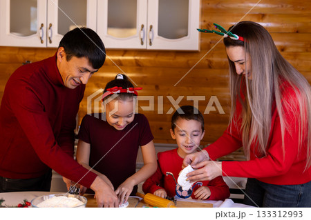 A family is baking Christmas cookies together in the kitchen A family is baking Christmas cookies together in the kitchen 133312993