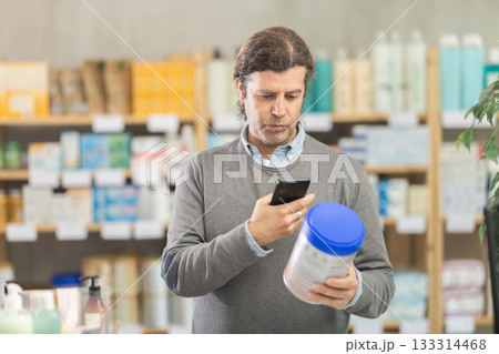 Adult man scanning qr code of baby formula Adult man scanning qr code of baby formula 133314468