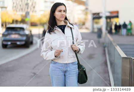 Girl traveler walks through tourist area of European city Girl traveler walks through tourist area of European city 133314489