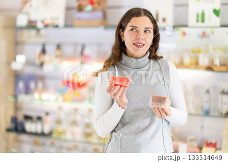 Young woman choosing handmade soap in store 133314649