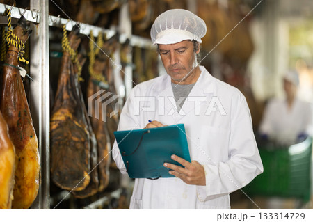 Man technologist makes an inventory at the jamon factory Man technologist makes an inventory at the jamon factory 133314729