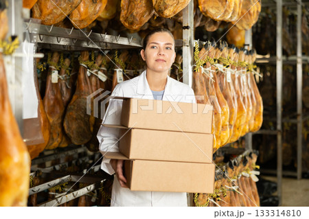 Employee of the jamon factory with boxes 133314810