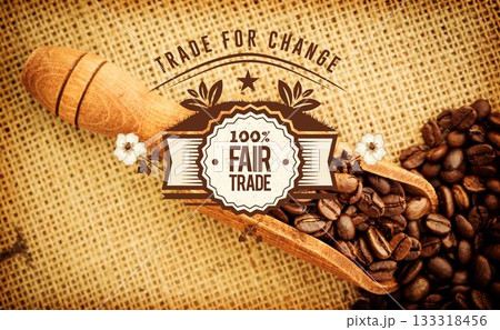 Wooden scoop is holding coffee beans and fair trade emblem in flat design on burlap fabric Wooden scoop is holding coffee beans and fair trade emblem in flat design on burlap fabric 133318456