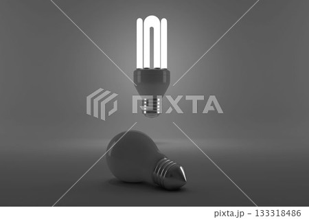 Lit energy efficient lightbulb over bulb 133318486