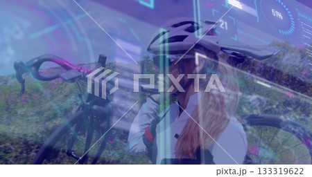 Shouldering bicycle cyclist moving along roadside path, with helmet sunglasses gloves data overlay 133319622