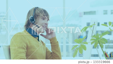 Talking headset-wearing mustard-sweater agent using mic at office desk, with monitor, copy space Talking headset-wearing mustard-sweater agent using mic at office desk, with monitor, copy space 133319666