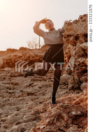 Woman Rocks Pose Outdoors Sunset: Fashion photography, rocky terrain, playful model. 133321876