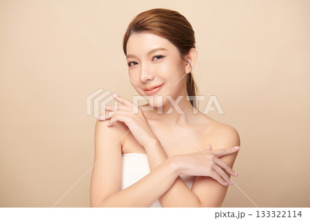 A beautiful young Asian woman with clean, fresh skin against a beige background. Skincare, facial treatment, cosmetology, beauty, and spa. An elegant portrait of an Asian woman. A beautiful young Asian woman with clean, fresh skin against a beige background. Skincare, facial treatment, cosmetology, beauty, and spa. An elegant portrait of an Asian woman. 133322114