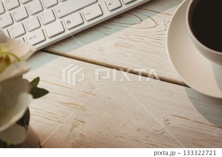 Keyboard and coffee cup on table 133322721