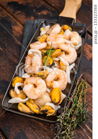 Seafood Cocktail appetiser with Mussels, Clams, Prawns, Shrimps and squid. wooden background. top view Seafood Cocktail appetiser with Mussels, Clams, Prawns, Shrimps and squid. wooden background. top view 133323569