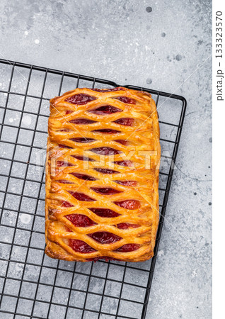 Danish pastry with a strawberry and cream cheese filling. grey background. top view Danish pastry with a strawberry and cream cheese filling. grey background. top view 133323570