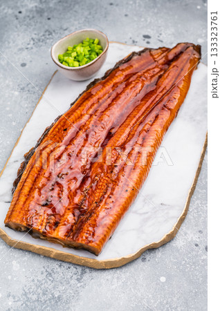 Unagi eel, Japanese grilled fish fillet of eel with sauce. grey background. top view 133323761
