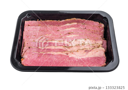 Sliced pastrami arranged in a black plastic container on a clean white background. Smoked deli beef with marbled texture, ready for sandwiches, cooking and meal preparation. Sliced pastrami arranged in a black plastic container on a clean white background. Smoked deli beef with marbled texture, ready for sandwiches, cooking and meal preparation. 133323825