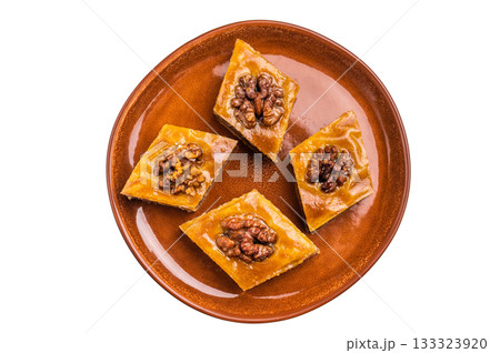Delicious Honey Walnut Baklava on plate isolated on white background. top view Delicious Honey Walnut Baklava on plate isolated on white background. top view 133323920