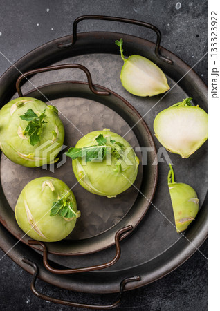 Raw kohlrabi on steel tray, Vegetable from Organic farm. black backround. top view 133323922