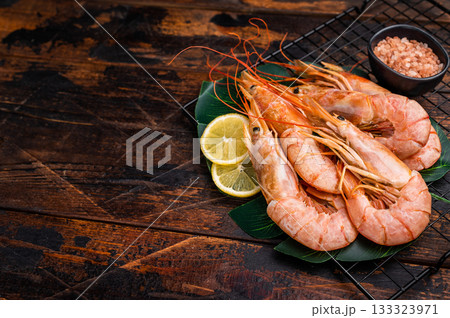 Raw Red Langostino Austral shrimps on rack with herbs. wooden background. top view Raw Red Langostino Austral shrimps on rack with herbs. wooden background. top view 133323971